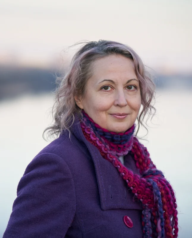Mature woman smiling wearing purple coat